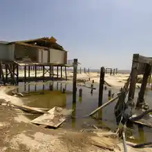 FEMA disaster-response photo of hurricane structural damage on Dauphin Island, Mobile County, AL -- storm damage is a common trigger for post-hurricane pest emergency calls