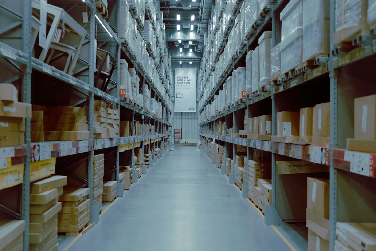 Rows of racked pallets inside a large commercial warehouse — the kind of facility commercial pest operators service in Mobile, AL