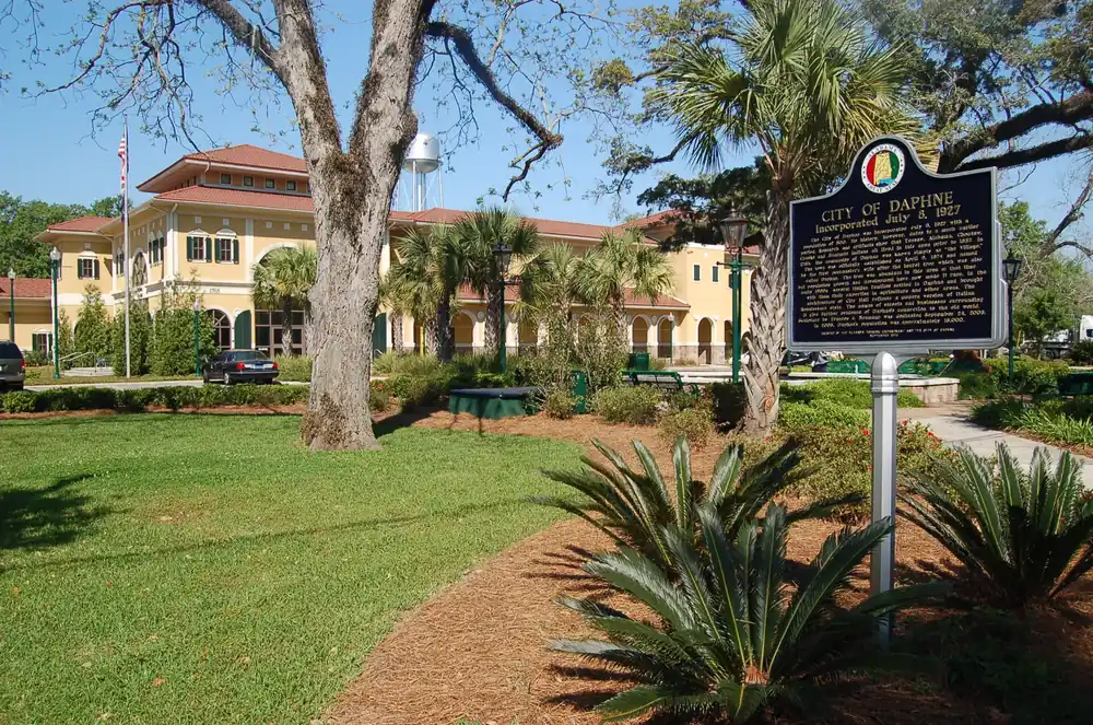 City of Daphne, Alabama municipal grounds with the historic city marker under live oak canopy
