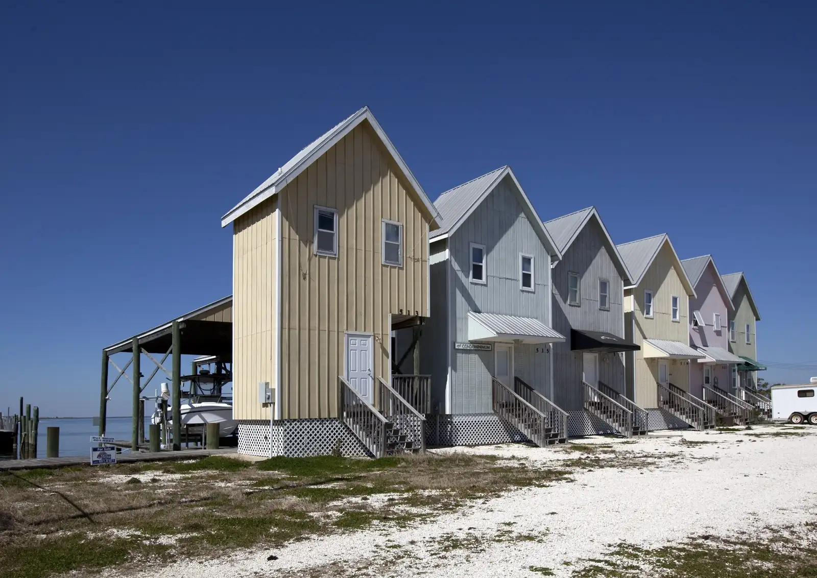 Beachfront cottages raised on pilings along the shoreline at Dauphin Island, Alabama