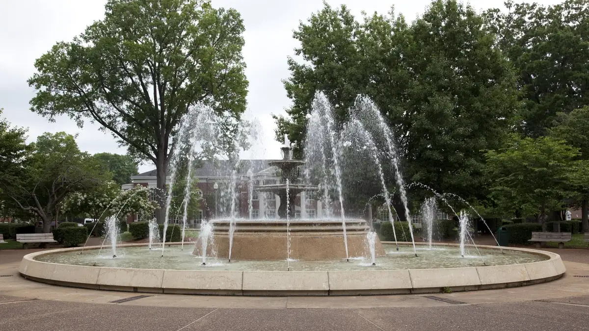 Downtown park fountain in Florence, AL, where Shoals-area humidity and older housing stock drive rodent and roach calls