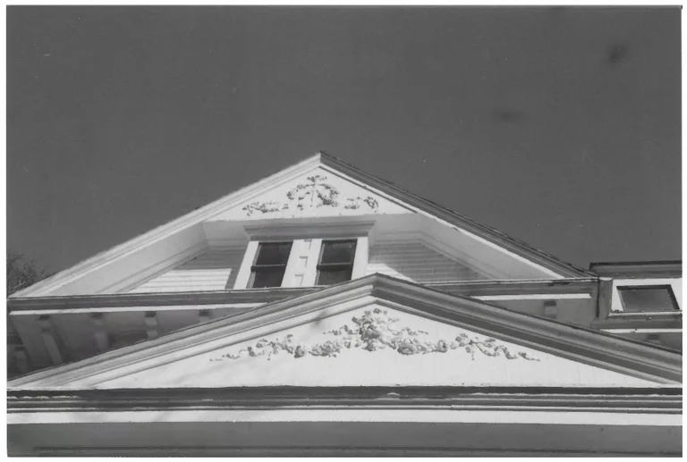 Pediment detail on the historic Bell House in Prattville, Alabama — mill-era construction that pairs century-old sills with a high water table