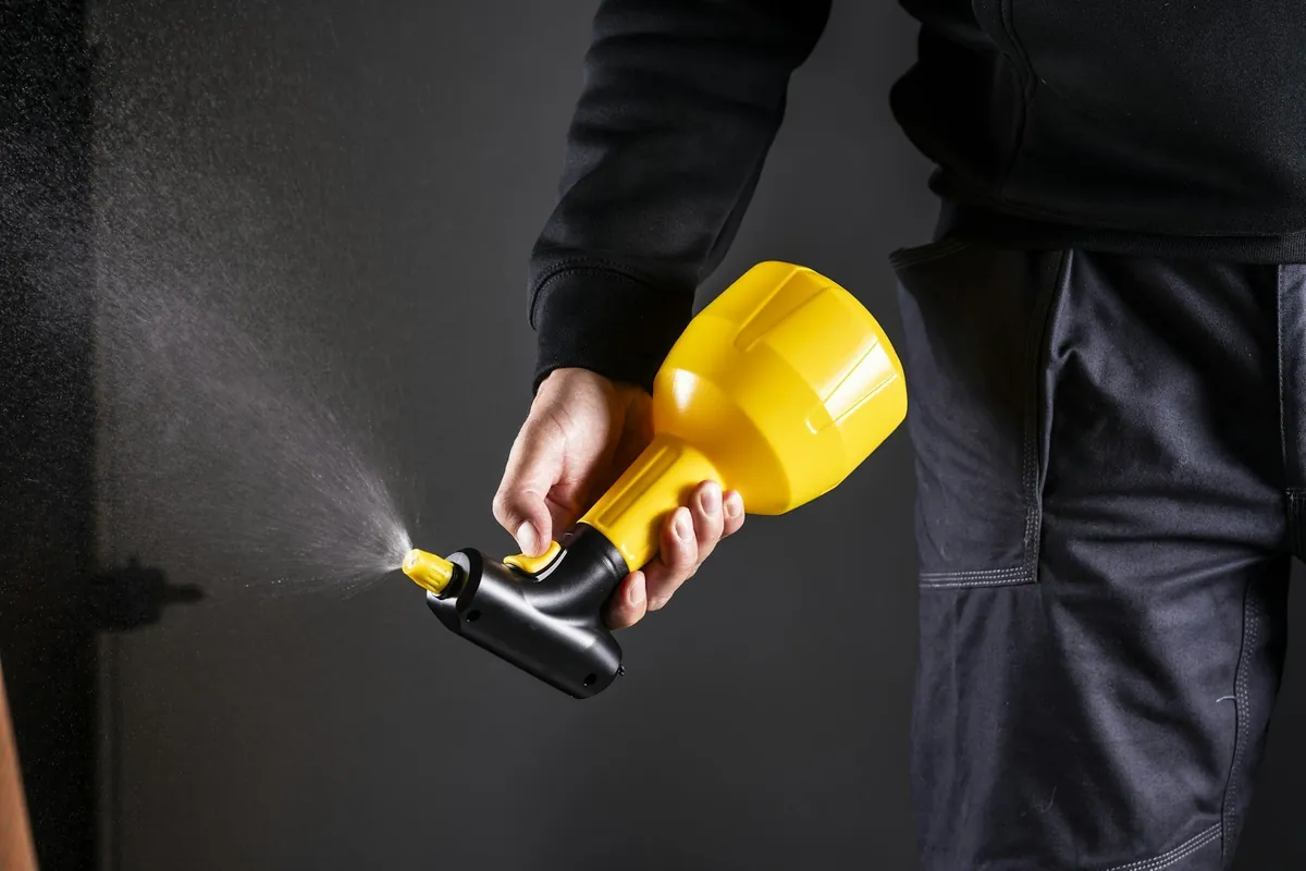 Pest control technician holding a sprayer — perimeter pest service in Mobile and Baldwin County, AL