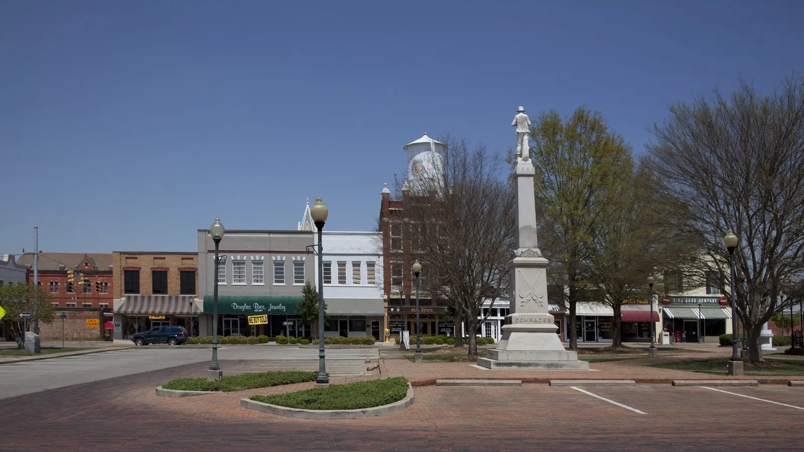 Downtown square in Troy, AL, where Pike County rental turnover and warm nights sustain roach and ant activity