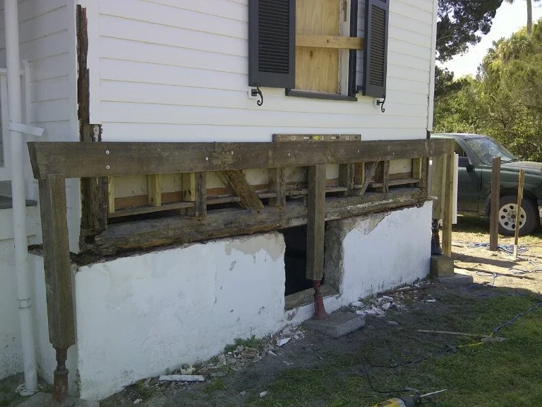 Replaced structural support beam under a raised house — the repair a Tillmans Corner, Mobile AL termite inspection is meant to catch years earlier