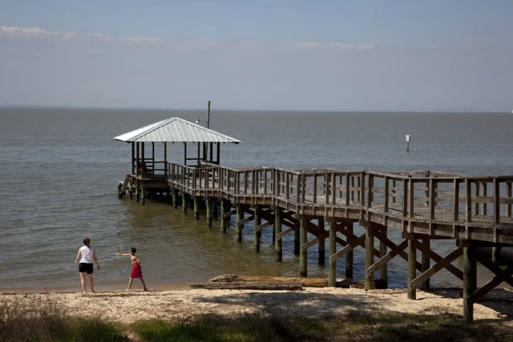 Fairhope pier reaching into Mobile Bay — the bayfront humidity that shapes pest pressure in Fairhope AL