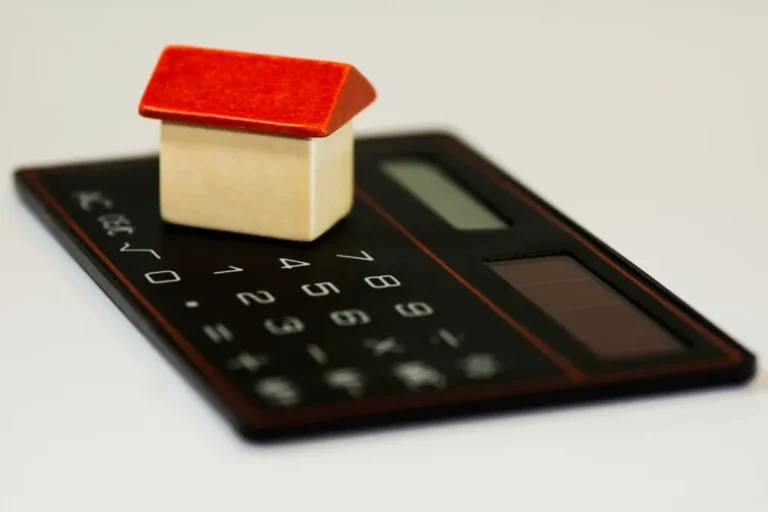 House model on a calculator — the variables behind termite treatment cost in Mobile AL